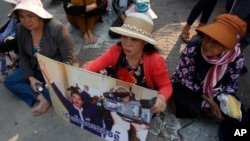 Boeung Kak lake community's land activists shout slogans with a poster of a detained activist during a rally in front of the Supreme Court, in Phnom Penh, Cambodia, Feb. 7, 2018. 