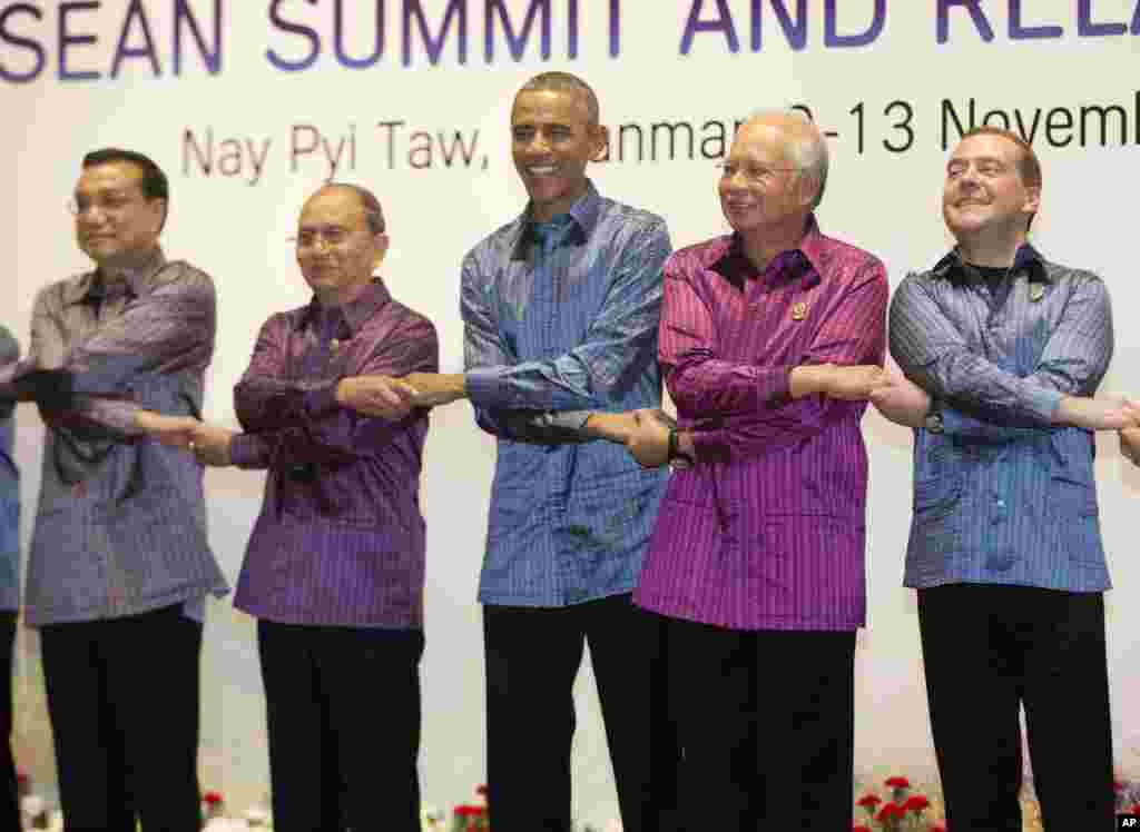 President Barack Obama and Myanmar President Thein Sein, second from left, pose during the East Asia Summit family photo at the Myanmar International Convention Center, Nov. 12, 2014, in Naypyitaw, Myanmar.