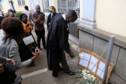 Lawyers stage a protest outside the High Court while awaiting a bail hearing for jailed journalist Hopwell Chin'ono, in Harare, Zimbabwe, Sept. 2, 2020.