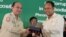 Om Yentieng, head of the government Anti-Corruption Unit, hands award to an outstanding reporter on corruption in Phnom Penh, July 22, 2015. (Hean Socheata/VOA Khmer)