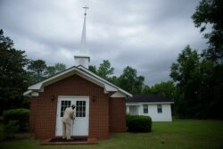 Eddie Keith, 65, of Dawson, Ga., locks the church doors as he leaves on April 19, 2020, in Dawson, Ga. He visits his pastor's church a couple times a week.