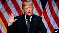 FILE - President Donald Trump lays out a national security strategy.