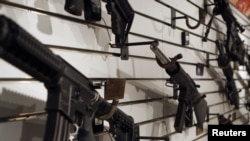 Assault rifles are displayed during the NRA Annual Meeting & Exhibits in Phoenix, Arizona May 15, 2009. REUTERS/Joshua Lott