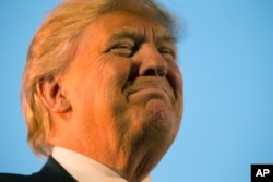 FILE - Then-presidential candidate Donald Trump pauses during while speaking at a rally in Millington, Tenn., Feb. 27, 2016. Tough talk about torture was a guaranteed applause line for Trump on the GOP presidential stump.