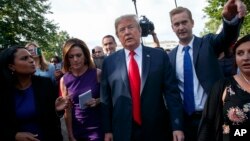 President Donald Trump walks to an interview on the North Lawn of the White House, June 15, 2018, in Washington. 