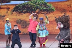 Chinese actor Lou Naiming, 2nd right, performs a skit on a Lunar New Year gala in Beijing, China, Feb. 15, 2018.