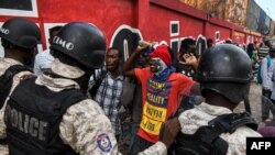 Demonstrators protest outside the United Nation's main base, against President Jovenel Moise on Oct. 4, 2019, in Port-au-Prince, Haiti. 
