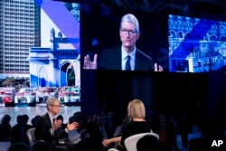 Apple CEO Tim Cook, lower left, speaks at the Bloomberg Global Business Forum, Sept. 20, 2017, in New York.