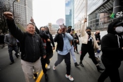 People react following the verdict in the trial of former Minneapolis police officer Derek Chauvin, found guilty of the death of George Floyd, outside the Hennepin County Government Center in Minneapolis, Minnesota, U.S., April 20, 2021. REUTERS/Nicholas