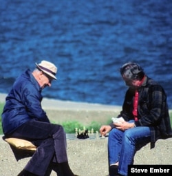Two men enjoy the sunshine along Lake Michigan with a friendly game of chess. (Photo by Steve Ember)