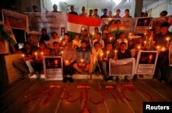 People pay tribute to Central Reserve Police Force personnel who were killed in an explosion in south Kashmir, inside a temple in Ahmedabad, India, Feb. 14, 2019.