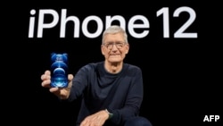 In this photo released by Apple, Apple CEO Tim Cook holds up the all-new iPhone 12 Pro during an Apple event at Apple Park in Cupertino, California on October 13, 2020. (Photo by Brooks KRAFT / Apple Inc. / AFP)