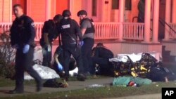 FILE - In a still frame from video first responders tend to an injured man at a Nov. 25, 2023, shooting in Burlington, Vt. Burlington Police Department arrested Jason J. Eaton, suspected in the shooting of three young men of Palestinian descent.