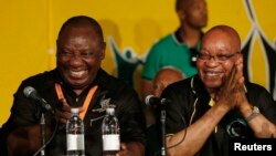 FILE - South Africa's President Jacob Zuma, right, jokes with his deputy, Cyril Ramaphosa, after Zuma's re-election in 2012. A powerful union group has backed Ramaphosa to succeed President Jacob Zuma as head of the ruling party.