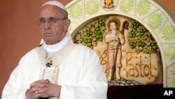 FILE - Pope Francis prays during a Mass at Rizal Park, in Manila, Philippines, Jan. 18, 2015. 
