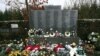 FILE - Floral tributes are laid by the main memorial stone in memory of the victims of Pan Am flight 103 bombing, in the garden of remembrance at Dryfesdale Cemetery, near Lockerbie, Scotland, Dec. 21, 2018.