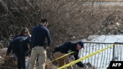 .ບັນດາ​ເຈົ້າ​ໜ້າ​ທີ່​ສືບ​ສວນ​ເກັບ​ກຳ​ຊິ້ນ​ສ່ວນ​ຂອງ​ຊາກ​ຫັກ​ພັງ​ຢູ່​ຕາມ​ແມ່​ນ້ຳ Potomac ທີ່ເປັນເຂດຊາຍແດນລະຫວ່າງ ນະຄອນຫຼວງ ວໍຊິງຕັນ ແລະເມືອງອາຣລິງຕັນ ຂອງລັດເວີຈີເນຍ. (Photo by ANDREW CABALLERO-REYNOLDS / AFP)