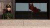 FILE - A paramilitary policeman stands guard at an entrance of China's Supreme Court in Beijing.