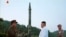 FILE - This image made from video of an undated still image broadcasted in a news bulletin on May 30, 2017, by North Korea's KRT shows North Korean leader Kim Jong Un and a missile launcher in North Korea. 