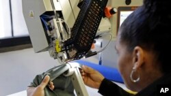 A woman works with fabric at 99Degrees Custom, in Lawrence, Mass. On Wednesday, March 8, 2017, the Labor Department issues revised data on productivity in the fourth quarter, March 3, 2017.