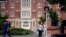 FLE- A University of Connecticut student waits for the traffic light to change outside a dormitory building on the campus in Storrs, Conn., Sept. 18, 2015.