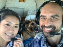 Pilot Eduard Seitan and his fiancee, Debbie, sit in the cockpit of his plane. They are preparing to deliver a rescue dog to its new home.