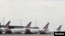 FILE - Air France planes are parked on the tarmac at the Paris Charles de Gaulle airport in Roissy, France, June 19, 2019. 