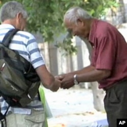 Khmer Rouge prison survivor, Chum Mey, sells books and magazines