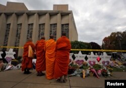 FILE - Monks pay their respects at a makeshift memorial outside the Tree of Life synagogue following Saturday's shooting at the synagogue in Pittsburgh, Penn., Oct. 29, 2018.