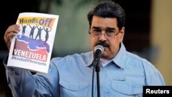 FILE - Venezuela's President Nicolas Maduro attends a gathering in support of his government in Caracas, Venezuela, Feb. 7, 2019.