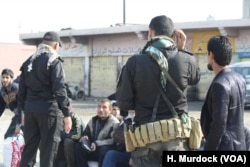 Men fleeing IS appear very much like the militants as they run, having been forced to grow beards and wear IS-style clothing in Gogjali, Mosul, Iraq, Nov. 7, 2016.