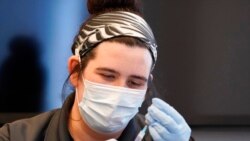 Paramedic Rebecca Hoke prepares a dose of the Pfizer-BioNTech COVID-19 vaccine for children 5 to 12 years old at a vaccination site in Fort Worth, Texas, Nov. 11, 2021.