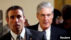 FILE : Special Counsel Robert Mueller, right, departs after briefing members of the U.S. Senate on his investigation into potential collusion between Russia and the Trump campaign on Capitol Hill in Washington, June 21, 2017. 