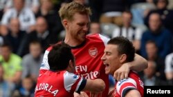 Demonstrators show symbolic red cards to Czech President Milos Zeman during a protest rally in Prague, Czech Republic.