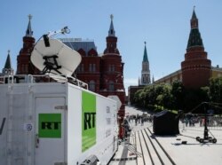 FILE - Vehicles of Russian state-controlled broadcaster RT are seen near the Red Square in Moscow, Russia, June 15, 2018.