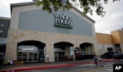 A shopper leaves a Whole Foods Market, June 16, 2017, in San Antonio, Texas.