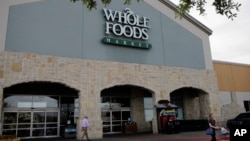 A shopper leaves a Whole Foods Market, June 16, 2017, in San Antonio, Texas.