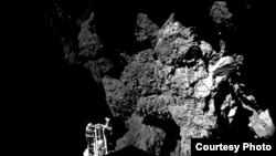 Lander Philae is safely on the surface of Comet 67P/Churyumov-Gerasimenko, as these first two CIVA images confirm. One of the lander’s three feet can be seen in the foreground. The image is a two-image mosaic, Nov. 13, 2014. (ESA) 