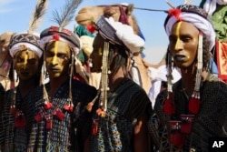 In this photo taken Feb. 17, 2018, people dress in traditional costume during a festival in Iferouane, Niger.