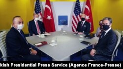 Turkey's President Recep Tayyip Erdogan (L back), Turkish Foreign Minister, Mevlut Cavusoglu (L), U.S. President Joe Biden (R back) and U.S. Secretary of State Antony Blinken (R) attend a meeting during the G20 Summit at the Roma Convention Center La Nuvola in Rome, Italy.