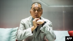 FILE - In this June 16, 2020, photo, media tycoon Jimmy Lai poses during an interview with AFP at the Next Digital offices in Hong Kong.