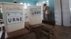 A voter fills out his ballot behind a privacy screen at a polling station in the Cocody neighborhood of Abidjan, April 21, 2013.