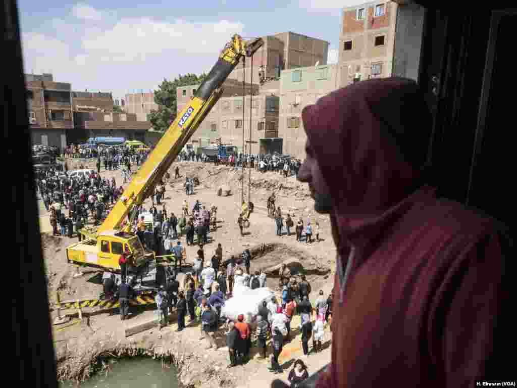 Ahmed watches the excavation of Ramses II statues. He said, &ldquo;the rest of the statues is under our house, hopefully they pull it, but they have to compensate with us and offer another place to live in."