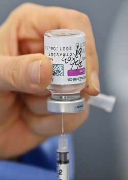 A nurse fills a syringe with the AstraZeneca COVID-19 vaccine at a health care center in Seoul, Feb. 26, 2021.