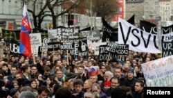 Demonstrators call for elections at a protest rally in Bratislava, Slovakia, March 16, 2018. They say the prime minister's resignation is not enough following the murder of Slovak investigative reporter Jan Kuciak and his fiancee, Martina Kusnirova. 