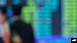 In this July 16, 2008, file photo, Macau casino mogul Stanley Ho reacts during the listing ceremony of Sociedade de Jogos de Macau, or SJM, at the Hong Kong Stock Exchange in Hong Kong.