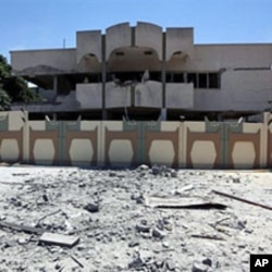 A picture taken during a government-guided tour on May 12, 2011 shows a damaged building in Bab al-Aziziya in Tripoli, following NATO air strikes on Libyan leader Moammer Gadhafi's compound