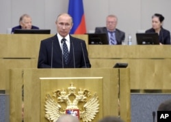 Russian President Vladimir Putin, foreground, speaks at an opening session of the newly elected State Duma, Russia's lower house of parliament, in Moscow, Russia, Oct. 5, 2016.
