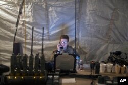 A U.S. Air Force service member uses radio communication at the command and control center inside a coalition air base in Qayyarah, some 50 kilometers south of Mosul, Iraq, Oct. 28, 2016. The U.S. military says Iraqi forces have retaken 40 villages from the Islamic State group near Mosul since a massive operation to drive the militants from the city began last week.