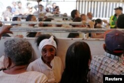Patients wait to be attended by staff of the United States Navy hospital ship USNS Comfort outside of the Divina Pastora high school in Riohacha, Colombia, Nov. 26, 2018.
